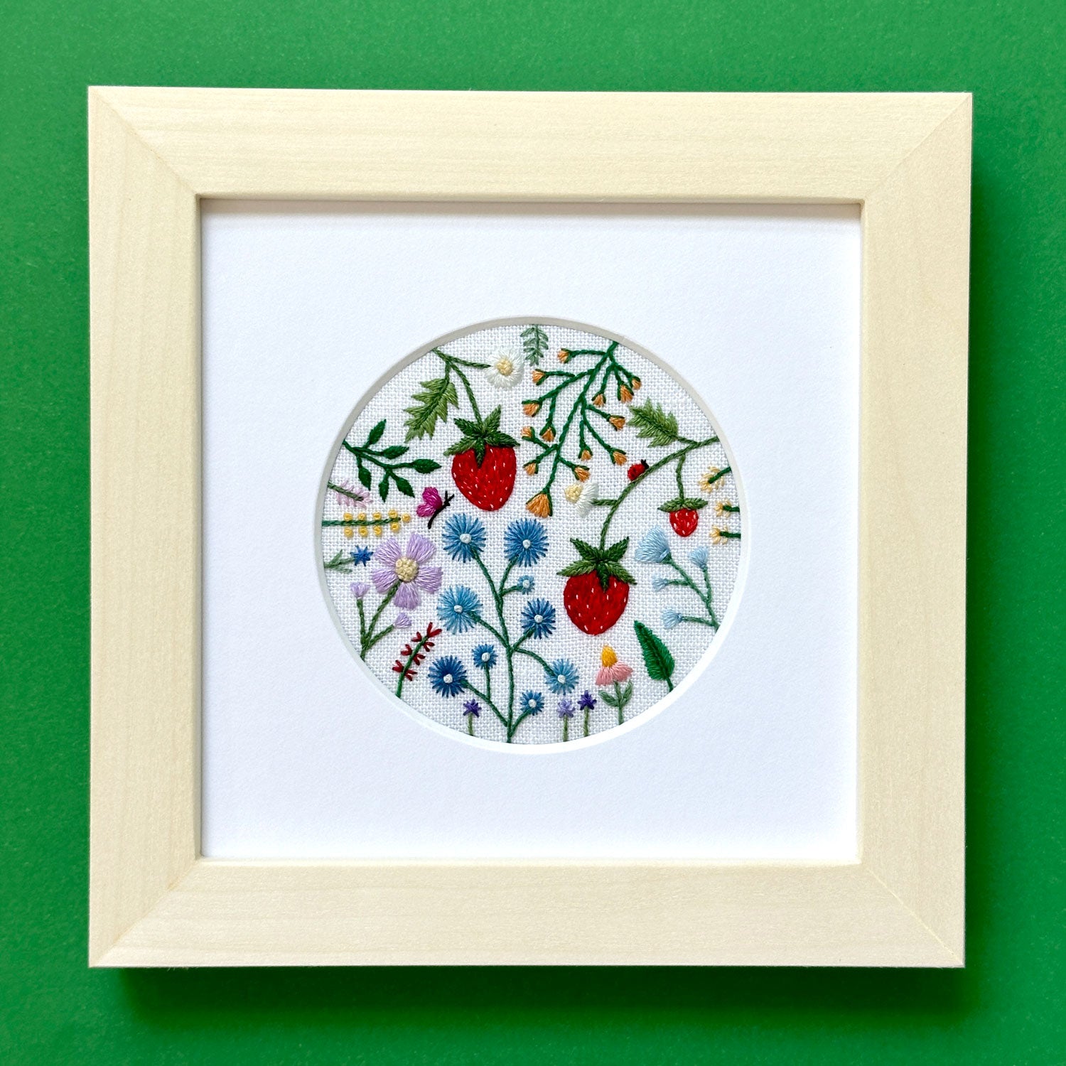 Spring Scene with Strawberries, Insects, and Flowers on White Linen Hand Embroidered Art