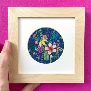 Overlapping Rainbow Flowers on Bright Blue Linen Hand Embroidered Art